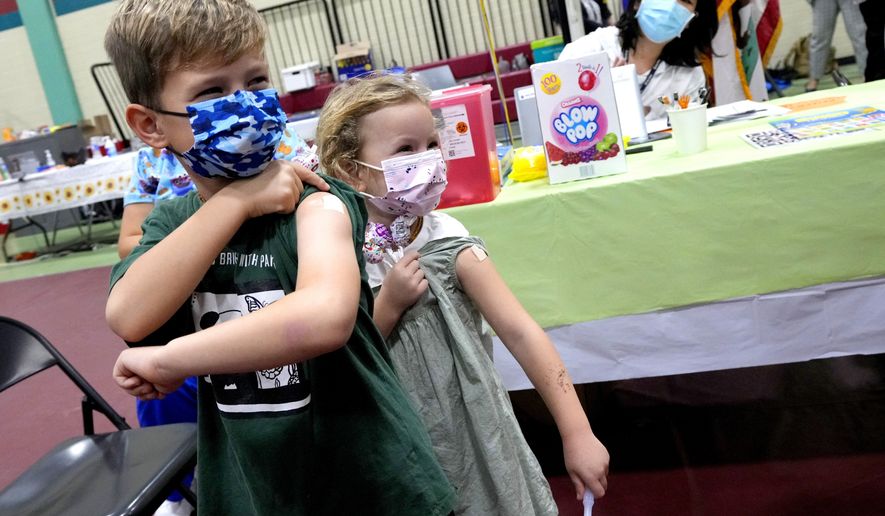 Wren Nagata, 7,  with his sister 5-year-old Mallory Nagata, of Pasadena, show off their bandaids after receiving their COVID-19 vaccines during an event kicking off coronavirus vaccinations for children age 5-11 at Eugene A. Obregon Park in Los Angeles on Wednesday, Nov. 3, 2021. (Keith Birmingham/The Orange County Register via AP)