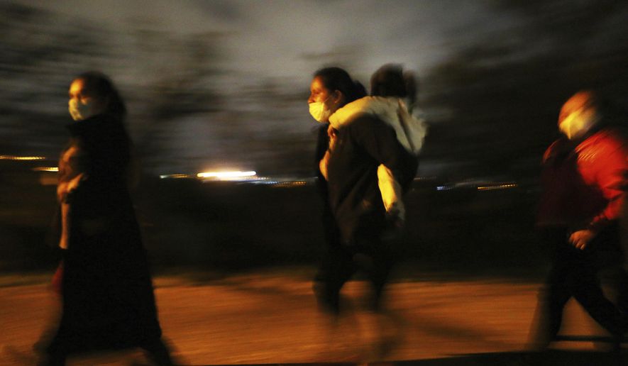 Migrants walk to be processed by the U.S. Border Patrol after crossing the Rio Grande on May 14, 2021, in Roma. Texas. Biden took office on Jan. 20 and almost immediately, numbers of migrants exceeded expectations. (Joel Martinez/The Monitor via AP, File)