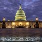 In this Jan. 21, 2018, file photo, lights shine inside the U.S. Capitol Building as night falls in Washington. (AP Photo/J. David Ake)