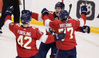 Florida Panthers center Eetu Luostarinen, rear, celebrates with defenseman Gustav Forsling (42) and center Frank Vatrano (77) after scoring the winning goal during an overtime period of an NHL hockey game against the Washington Capitals, Thursday, Nov. 4, 2021, in Sunrise, Fla. (AP Photo/Wilfredo Lee)
