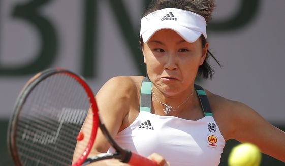 China&#x27;s Shuai Peng plays a shot against Romania&#x27;s Sorana Cirstea during their first round match of the French Open tennis tournament at the Roland Garros stadium, in Paris, France. Tuesday, May 30, 2017. Chinese authorities have squelched virtually all online discussion of sexual assault accusations apparently made by the Chinese professional tennis star against a former top government official, showing how sensitive the ruling Communist Party is to such charges. (AP Photo/Michel Euler, File)