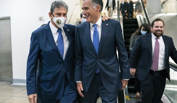 Sen. Joe Manchin, D-WVa., left and Sen. Mitt Romney, R-Utah, walk together on Capitol Hill in Washington, Thursday, Nov. 4, 2021. (AP Photo/Carolyn Kaster)