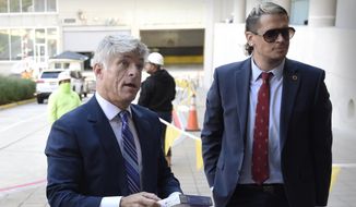St. Michael&#39;s Media founder and CEO Michael Voris, left, and Milo Yiannopoulos talk with a court officer before entering the federal courthouse, Sept. 30, 2021, in Baltimore. A federal appeals court has upheld a judge’s ruling that Baltimore city officials cannot ban the conservative Roman Catholic media outlet from holding a rally at a city-owned pavilion during a U.S. bishops’ meeting. (AP Photo/Gail Burton, File)