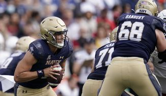 Navy quarterback Tai Lavatai runs withe the ball against Cincinnati during the first half of an NCAA college football game, Saturday, Oct. 23, 2021, in Annapolis, Md. (AP Photo/Julio Cortez) **FILE**
