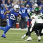 Indianapolis Colts&#x27; Jonathan Taylor (28) runs against New York Jets&#x27; Bryce Hall (37) during the first half of an NFL football game, Thursday, Nov. 4, 2021, in Indianapolis. (AP Photo/Michael Conroy)