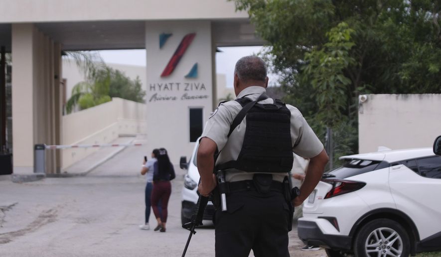 Mexican government forces guard the entrance of a resort hotel in this file photo. (AP Photo/Karim Torres)