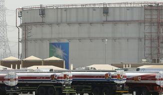 Fuel trucks line up in front of storage tanks at the North Jiddah bulk plant, an Aramco oil facility, in Jiddah, Saudi Arabia, on March 21, 2021. OPEC and allied oil-producing countries will decide on output levels Thursday Nov. 4 2021, with President Joe Biden urging alliance members Saudi Arabia and Russia to increase production and lower U.S. gasoline prices at the pump — so far to no avail. (AP Photo/Amr Nabil, File)