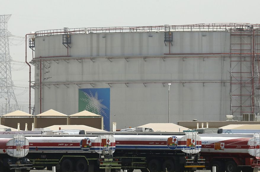 Fuel trucks line up in front of storage tanks at the North Jiddah bulk plant, an Aramco oil facility, in Jiddah, Saudi Arabia, on March 21, 2021. OPEC and allied oil-producing countries will decide on output levels Thursday Nov. 4 2021, with President Joe Biden urging alliance members Saudi Arabia and Russia to increase production and lower U.S. gasoline prices at the pump — so far to no avail. (AP Photo/Amr Nabil, File)