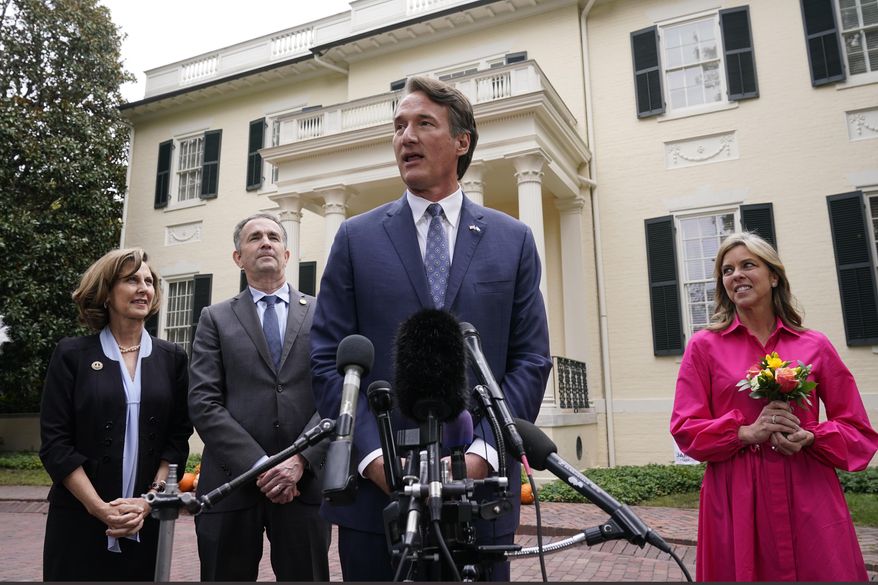 Virginia Gov.-elect, Glenn Youngkin, second from right, speaks to the media as Virginia Gov. Ralph Northam, second from left, Suzanne Youngkin, right, and Pam Northam look on after a transition meeting in Richmond, Va., Thursday, Nov. 4, 2021.