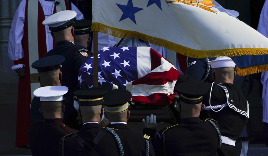 The flag-draped casket of former Secretary of State Colin Powell is carried into the Washington National Cathedral for a funeral service in Washington, Friday, Nov. 5, 2021. (AP Photo/Manuel Balce Ceneta)