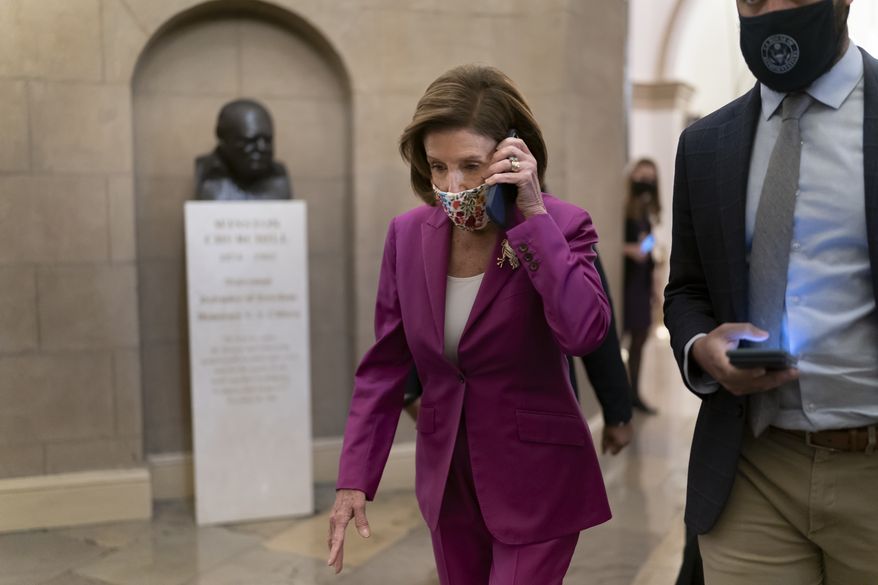 Speaker of the House Nancy Pelosi, D-Calif., arrives to lead Democrats in advancing President Joe Biden's $1.85 trillion-and-growing domestic policy package, at the Capitol in Washington, Friday, Nov. 5, 2021. The hard-fought social policy and climate-change legislation will still have to clear the 50-50-Senate, where revisions are likely and Biden has no votes to spare. (AP Photo/J. Scott Applewhite)