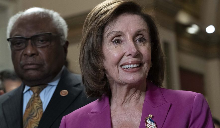 Speaker of the House Nancy Pelosi, D-Calif., accompanied by House Majority Whip James Clyburn, D-S.C., left speaks to reporters at the Capitol in Washington, Friday, Nov. 5, 2021. (AP Photo/Jose Luis Magana)