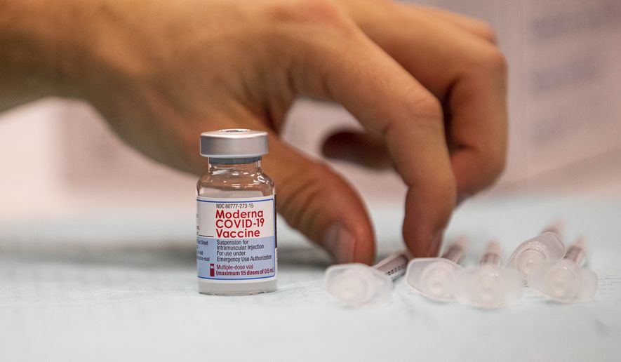 Alex Lewandowski prepares a dose of a Moderna COVID-19 vaccine on Thursday, Nov. 4, 2021, at a vaccine center in Barboursville, W.Va. (Sholten Singer/The Herald-Dispatch via AP) ** FILE **