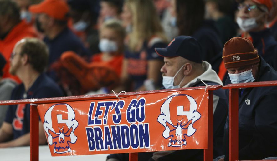 A sign reading &amp;quot;Let&#x27;s go Brandon&amp;quot; is displayed on the railing in the first half of an NCAA college football game between Boston College and Syracuse in Syracuse, N.Y., Saturday, Oct. 30, 2021. Critics of President Joe Biden have come up with the cryptic new phrase to insult the Democratic president. (AP Photo/Joshua Bessex)