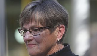 This photo from Monday, Oct. 4, 2021, shows Kansas Gov. Laura Kelly after an event in Topeka, Kan. The Democratic governor is suggesting that President Joe Biden&#39;s COVID-19 vaccine mandates will be difficult for the state to deal with and is questioning whether they will work even though mandates have boosted inoculation rates in other places. (AP Photo/John Hanna)