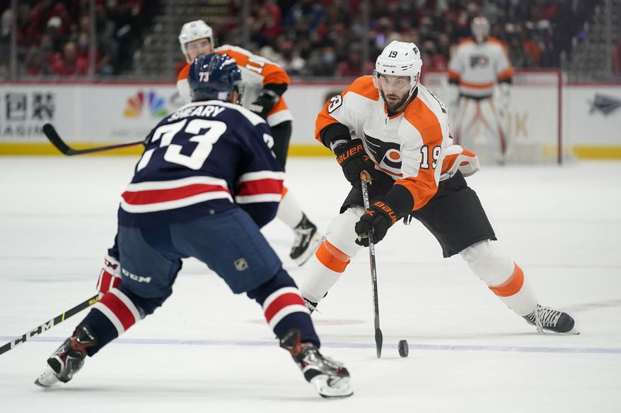 Philadelphia Flyers center Derick Brassard, right, skates with the puck against Washington Capitals left wing Conor Sheary in the first period of an NHL hockey game, Saturday, Nov. 6, 2021, in Washington. (AP Photo/Patrick Semansky)
