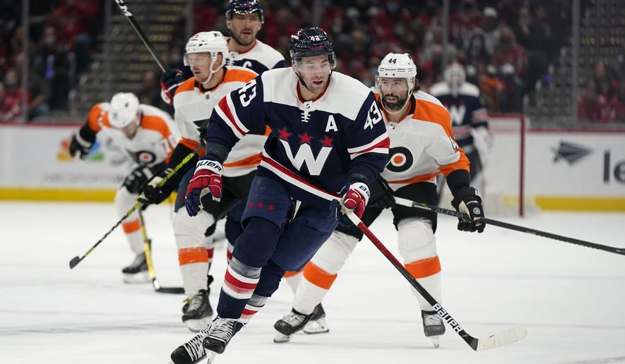 Washington Capitals right wing Tom Wilson (43) chases after the puck in the second period of an NHL hockey game against the Philadelphia Flyers, Saturday, Nov. 6, 2021, in Washington. (AP Photo/Patrick Semansky) **FILE**