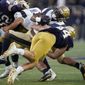 Notre Dame linebacker Kahanu Kia (44) tackles Navy fullback Maquel Haywood (24) in the second half of an NCAA college football game in South Bend, Ind., Saturday, Nov. 6, 2021. (AP Photo/Paul Sancya)