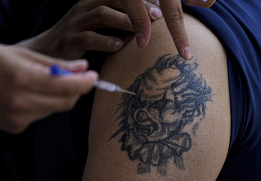 FILE - A youth receives a shot of Russia&#39;s Sputnik V coronavirus vaccine during a vaccination drive at University Stadium in Mexico City, July 23, 2021. On Monday, the U.S. will implement a new air travel policy to allow in foreign citizens who have completed a course of a vaccine approved by the Food and Drug Administration or the World Health Organization. That leaves people in Mexico, Hungary, Russia and elsewhere who received the non-approved Russian Sputnik V vaccine or the China-produced CanSino vaccine ineligible to board U.S.-bound flights. (AP Photo/Fernando Llano, File)