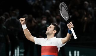Serbia&#39;s Novak Djokovic celebrates defeating Russia&#39;s Daniil Medvedev during the final match of the Paris Masters tennis tournament at the Accor Arena in Paris, Sunday, Nov.7, 2021. Djokovic won 4-6, 6-3, 6-3. (AP Photo/Thibault Camus)