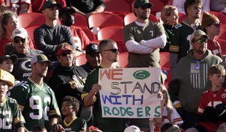 A fan holds a sign in support of Green Bay Packers quarterback Aaron Rodgers before the start of an NFL football game between the Kansas City Chiefs and the Green Bay Packers Sunday, Nov. 7, 2021, in Kansas City, Mo. (AP Photo/Charlie Riedel) **FILE**