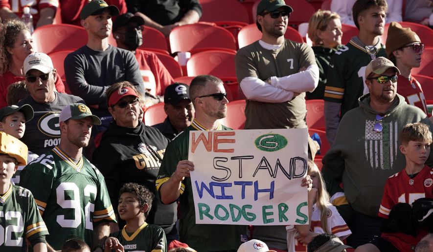 A fan holds a sign in support of Green Bay Packers quarterback Aaron Rodgers before the start of an NFL football game between the Kansas City Chiefs and the Green Bay Packers Sunday, Nov. 7, 2021, in Kansas City, Mo. (AP Photo/Charlie Riedel) **FILE**