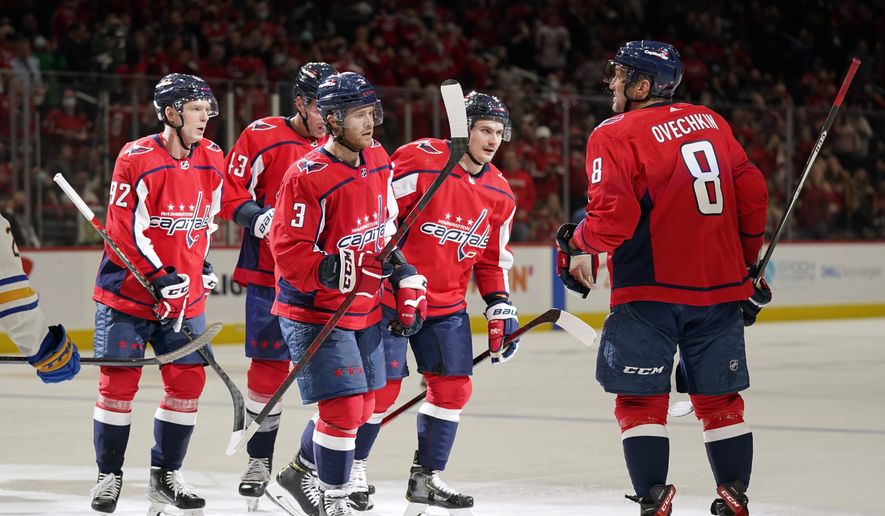Washington Capitals left wing Alex Ovechkin (8) celebrates his goal with teammates in the second period of an NHL hockey game against the Buffalo Sabres, Monday, Nov. 8, 2021, in Washington. (AP Photo/Patrick Semansky)