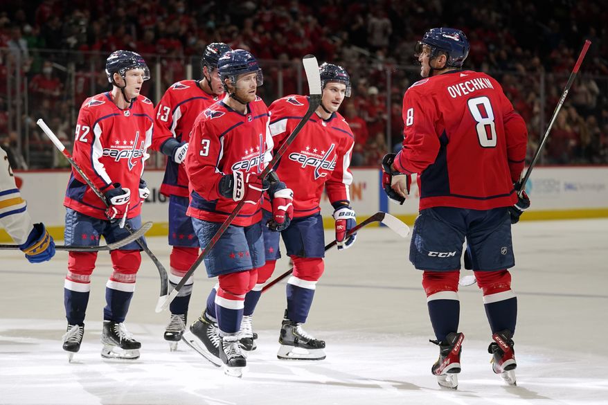 Washington Capitals left wing Alex Ovechkin (8) celebrates his goal with teammates in the second period of an NHL hockey game against the Buffalo Sabres, Monday, Nov. 8, 2021, in Washington. (AP Photo/Patrick Semansky)