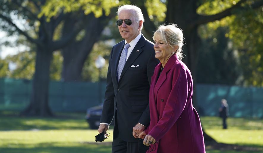 President Joe Biden and first lady Jill Biden arrive on the South Lawn of the White House after spending the weekend in Rehoboth Beach, Del., Monday, Nov. 8, 2021, in Washington. (AP Photo/Evan Vucci)