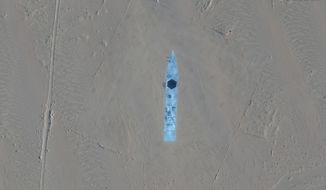 This satellite image provided by Maxar Technologies shows a designated area in Ruoqiang county, China, Wednesday, Oct. 20, 2021. Satellite images appear to show China has built mock-ups of U.S. Navy aircraft carriers and destroyers in its northwestern desert, such as one in this image, possibly as practice for a future naval clash as tensions rise between the nations. (Maxar Technologies via AP)