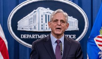 Attorney General Merrick Garland speaks at a news conference at the Justice Department in Washington, Monday, Nov. 8, 2021. Two suspected criminal hackers have been charged in the United States in connection with a wave of ransomware attacks. That includes one that led to the temporary shutdown of the world’s largest meat processor and another that snarled businesses around the globe on the Fourth of July weekend. Garland and other top officials announced charges Monday against Ukrainian Yaroslav Vasinskyi and Russian Yevgeniy Polyanin, alleging them to be part of the REvil ransomware gang.(AP Photo/Andrew Harnik)