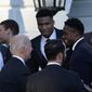 President Joe Biden talks with members of the Milwaukee Bucks basketball team, including Giannis Antetokounmpo, center, during an event to celebrate their 2021 NBA Championship, on the South Lawn of the White House in Washington, Monday, Nov. 8, 2021. (AP Photo/Susan Walsh)