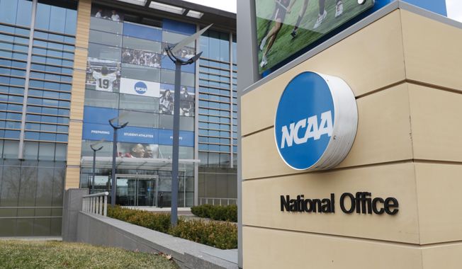 The NCAA headquarters in Indianapolis is shown in this Thursday, March 12, 2020. The NCAA on Monday, Nov. 8, 2021, set the stage for a dramatic restructuring of college sports that will give each of its three divisions the power to govern itself. (AP Photo/Michael Conroy, File) **FILE***