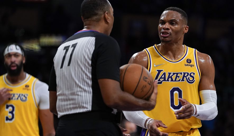 Los Angeles Lakers guard Russell Westbrook (0) disputes a call, causing a delay of game penalty during the second half of an NBA basketball game against the Charlotte Hornets in Los Angeles, Monday, Nov. 8, 2021. (AP Photo/Ashley Landis)