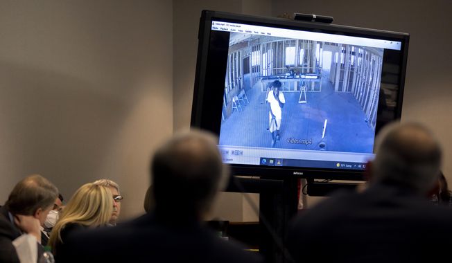 Prosecutor Linda Dunikoski shows a video of Ahmaud Arbery walking through a house under construction during the trial of Greg McMichael and his son, Travis McMichael, and a neighbor, William &quot;Roddie&quot; Bryan in the Glynn County Courthouse, Tuesday, Nov. 9, 2021, in Brunswick, Ga. The three are charged with the February 2020 slaying of 25-year-old Ahmaud Arbery. (AP Photo/Stephen B. Morton, Pool)