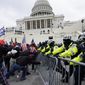 Trump supporters try to break through a police barrier at the Capitol in Washington on Jan. 6, 2021. ​(AP Photo/Julio Cortez, File)