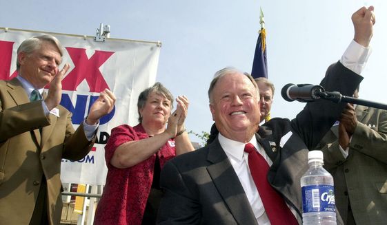 Then-Sen. Max Cleland, D-Ga., foreground, raises his hand to the crowd at a campaign rally in downtown Atlanta, Wednesday, Aug. 21, 2002. Cleland, who lost three limbs to a Vietnam War hand grenade blast yet went on to serve as a U.S. senator from Georgia, died on Tuesday, Nov. 9, 2021. He was 79. (AP Photo/Ric Feld, File)
