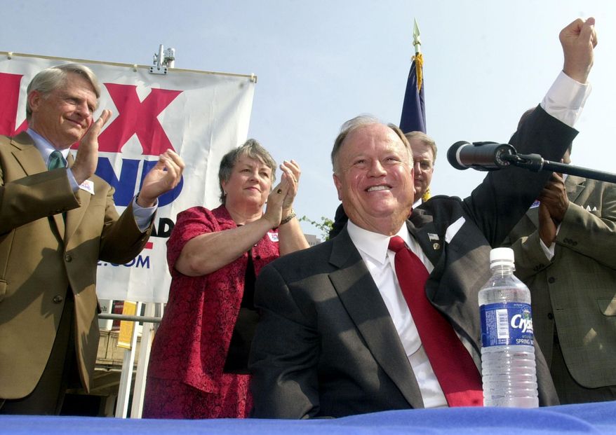 Then-Sen. Max Cleland, D-Ga., foreground, raises his hand to the crowd at a campaign rally in downtown Atlanta, Wednesday, Aug. 21, 2002. Cleland, who lost three limbs to a Vietnam War hand grenade blast yet went on to serve as a U.S. senator from Georgia, died on Tuesday, Nov. 9, 2021. He was 79. (AP Photo/Ric Feld, File)