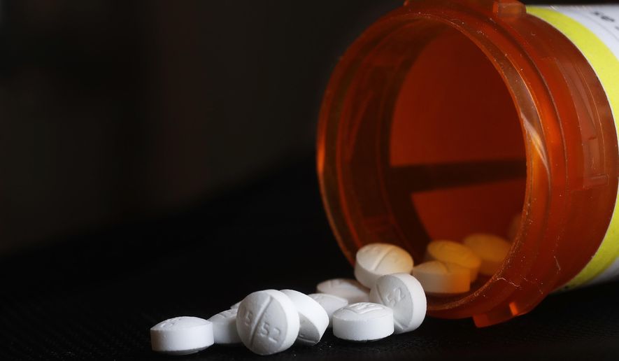 This photo shows an arrangement of Oxycodone pills in New York on Aug. 29, 2018. The Oklahoma Supreme Court has overturned a $465 million opioid ruling against drugmaker Johnson &amp;amp; Johnson, finding that a lower court wrongly interpreted the state&#39;s public nuisance law. The court ruled in a 5-1 decision Tuesday, Nov. 9, 2021, that the district court in 2019 was wrong to find that New Jersey-based J&amp;amp;J and its Belgium-based subsidiary Janssen Pharmaceuticals violated the state&#39;s public nuisance statute. (AP Photo/Mark Lennihan, File)