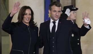 French President Emmanuel Macron and Vice President Kamala Harris wave Wednesday, Nov. 10, 2021 at the Elysee Palace in Paris. Kamala Harris will try to smooth French feathers after a diplomatic crisis. The U.S.-France relationship hit a historic low this year after a U.S.-British submarine deal with Australia scuttled a French contract to sell subs to the Australian navy. (AP Photo/Christophe Ena)