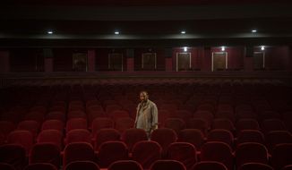 Gul Mohammed, who works as a host in the Ariana Cinema, poses for a photograph in Kabul, Afghanistan, Thursday, Nov. 4, 2021. After seizing power three months ago, the Taliban ordered cinemas to stop operating.(AP Photo/Bram Janssen)