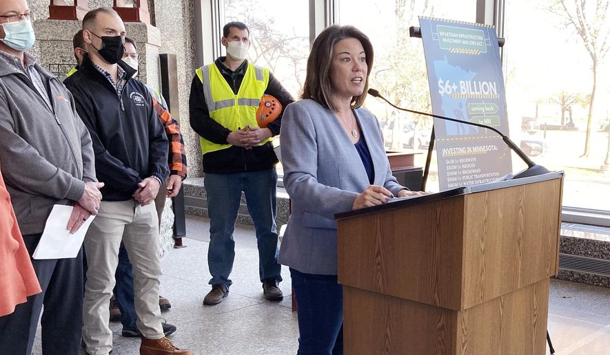 Rep. Angie Craig, D-Minn., speaks about the new infrastructure bill during a news conference Tuesday, Nov. 9, 2021, at the Minnesota Department of Transportation in St. Paul, Minn. Standing behind her are officials from local building trade unions. Minnesota will be getting over $6 billion as part of the package. (AP Photo/Steve Karnowski)