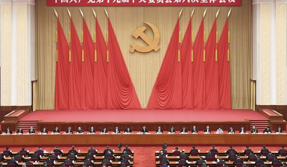 In this photo released on Nov. 11, 2021, by Xinhua News Agency, members of the Standing Committee of the Political Bureau of the Communist Party of China (CPC) Central Committee, including Chinese President Xi Jinping attend the sixth plenary session of the 19th Central Committee of the Communist Party of China (CPC) in Beijing. Words on the banner reads &quot;The 19th Communist Party of China Central Committee sixth plenary session&quot; (Zhai Jianlan/Xinhua via AP)