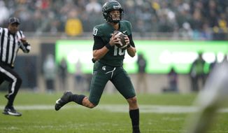Michigan State quarterback Payton Thorne scrambles against Michigan during an NCAA college football game, Saturday, Oct. 30, 2021, in East Lansing, Mich. (AP Photo/Al Goldis)