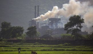 Smoke rises from a coal-powered steel plant at Hehal village near Ranchi, in eastern state of Jharkhand, Sunday, Sept. 26, 2021. No country will see energy needs grow faster in coming decades than India, and even under the most optimistic projections part of that demand will have to be met with dirty coal power — a key source of heat-trapping carbon emissions. (AP Photo/Altaf Qadri)