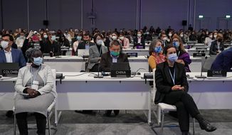 Delegates pack the hall at the COP26 U.N. Climate Summit in Glasgow, Scotland, Thursday, Nov. 11, 2021. (AP Photo/Alberto Pezzali)