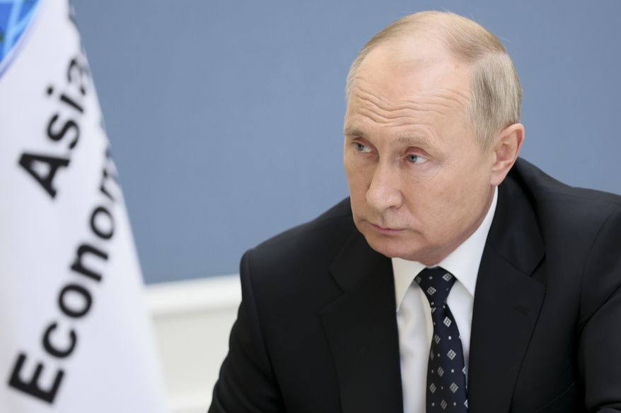 Russian President Vladimir Putin speaks during his interview with the Rossiya-1 TV channel in Moscow, Russia, Saturday, Nov. 13, 2021. Putin on Saturday rejected claims that Russia is connected to unfolding tensions over migrants and refugees amassing on the Belarus-Poland border. (Mikhail Metzel, Sputnik, Kremlin Pool Photo via AP)