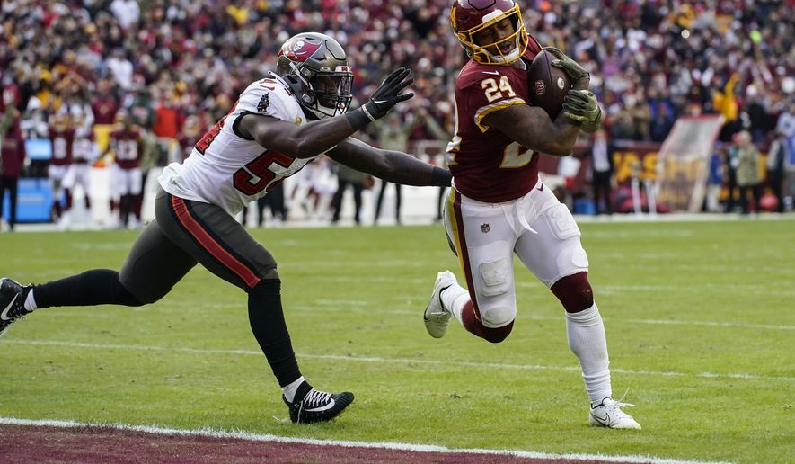 Washington Football Team running back Antonio Gibson (24) scores a touchdown in front of Tampa Bay Buccaneers inside linebacker Lavonte David (54) during the second half of an NFL football game Sunday, Nov. 14, 2021, in Landover, Md. (AP Photo/Patrick Semansky)