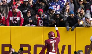 Washington Football Team wide receiver DeAndre Carter (1) celebrates his touchdown pass during the first half of an NFL football game against the Tampa Bay Buccaneers, Sunday, Nov. 14, 2021, in Landover, Md. (AP Photo/Nick Wass)