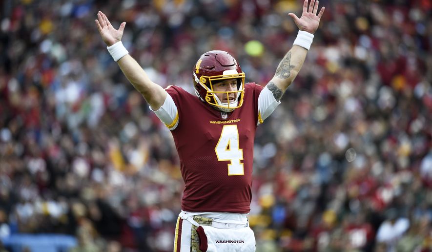 Washington Football Team quarterback Taylor Heinicke celebrates a touchdown during an NFL football game against the Tampa Bay Buccaneers, Sunday, Nov. 14, 2021, in Landover, Md. (AP Photo/Mark Tenally)